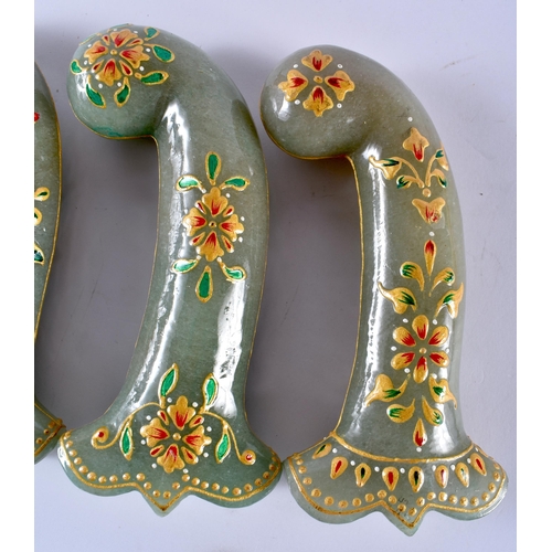 321 - A SET OF FIVE MIDDLE EASTERN QAJAR LACQUER HARDSTONE DAGGER HANDLES overlaid with foliage and vines.... 