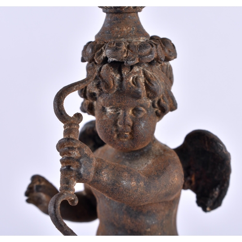 330 - A RARE PAIR OF EARLY 19TH CENTURY FRENCH CAST IRON CANDLESTICKS formed as putti holding bows, upon p... 