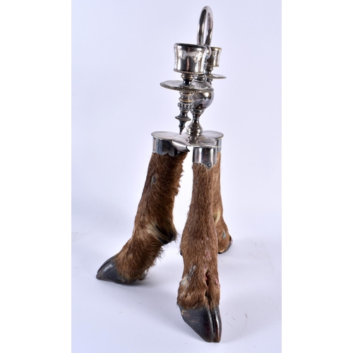 340 - A RARE VICTORIAN TAXIDERMY ROWLAND WARD CANDLESTICK formed with three deer hooves. 32 cm x 16 cm.