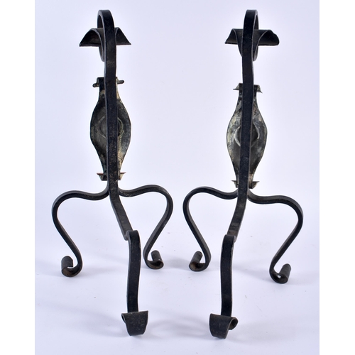 356 - A PAIR OF ARTS AND CRAFTS COPPER AND WROUGHT IRON ANDIRONS decorated with a motif. 35 cm x 14 cm.