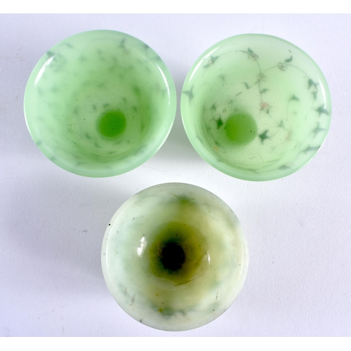 365 - A MIDDLE EASTERN ISLAMIC JADE TEABOWL together with two other bowls. Largest 6 cm diameter. (3)