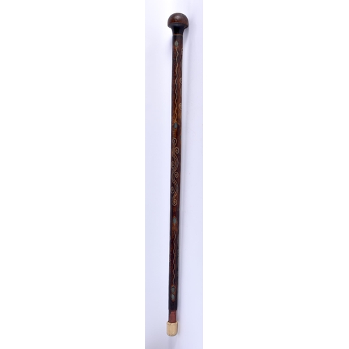 367 - A MIDDLE EASTERN MOTHER OF PEARL INLAID CARVED WOOD WALKING CANE. 90 cm long.