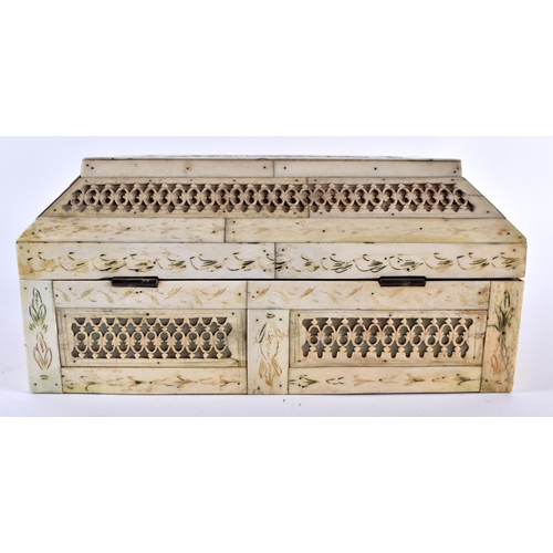 372 - A 19TH CENTURY CONTINENTAL CARVED BONE CASKET decorated all over with filigree motifs. 21 cm x 14 cm... 