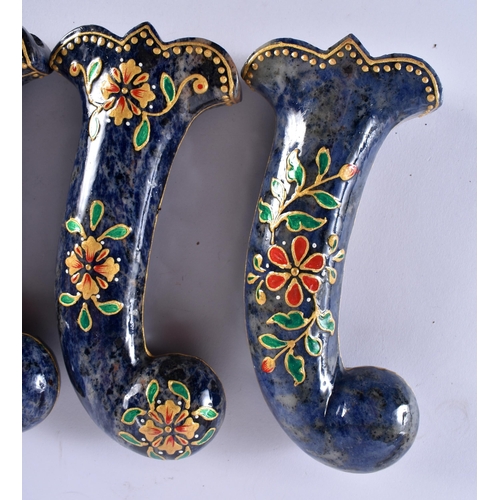 389 - A SET OF FIVE MIDDLE EASTERN QAJAR LACQUER HARDSTONE DAGGER HANDLES overlaid with foliage and vines.... 