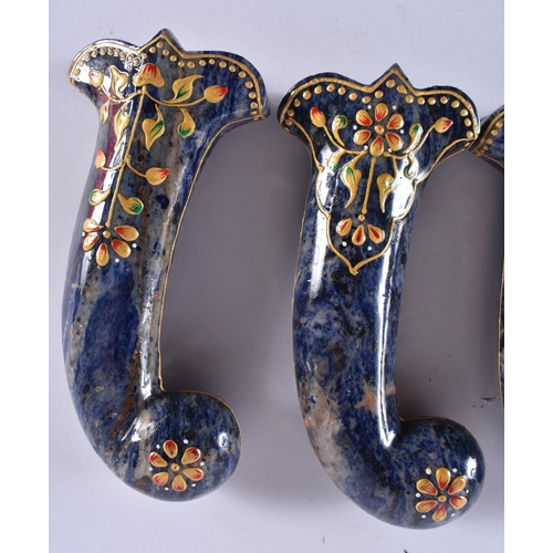 389 - A SET OF FIVE MIDDLE EASTERN QAJAR LACQUER HARDSTONE DAGGER HANDLES overlaid with foliage and vines.... 