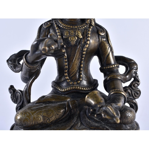 390 - A 19TH CENTURY TIBETAN NEPALESE BRONZE FIGURE OF A SEATED BUDDHA modelled holding Buddhistic items, ... 