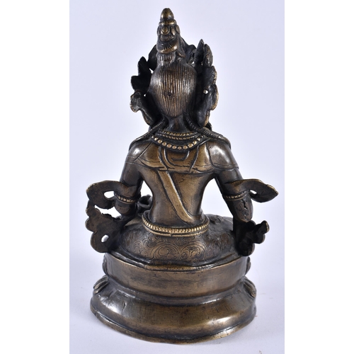 390 - A 19TH CENTURY TIBETAN NEPALESE BRONZE FIGURE OF A SEATED BUDDHA modelled holding Buddhistic items, ... 