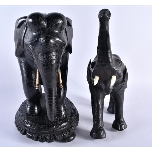 415 - A 19TH CENTURY ANGLO INDIAN COUNTRY HOUSE CARVED EBONY ELEPHANT together with a Liberty type leather... 