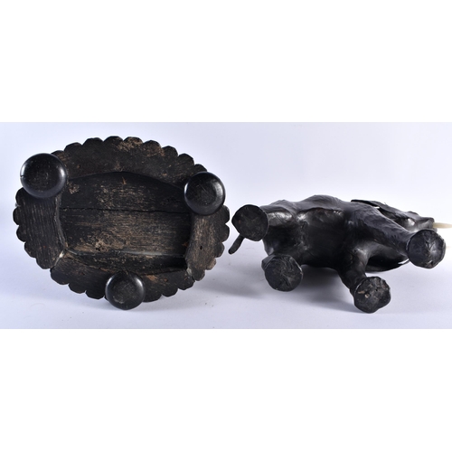 415 - A 19TH CENTURY ANGLO INDIAN COUNTRY HOUSE CARVED EBONY ELEPHANT together with a Liberty type leather... 