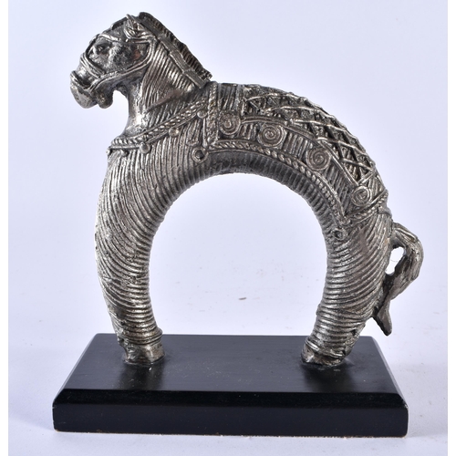 419 - AN INDIAN TRIBAL SILVERED BRONZE HORSE ANKLET upon an ebonised base. 15 cm x 12 cm.