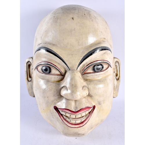 450 - A VERY LARGE EARLY 20TH CENTURY PAINTED MIDDLE EASTERN ASIAN WOOD MASK modelled as a laughing male. ... 