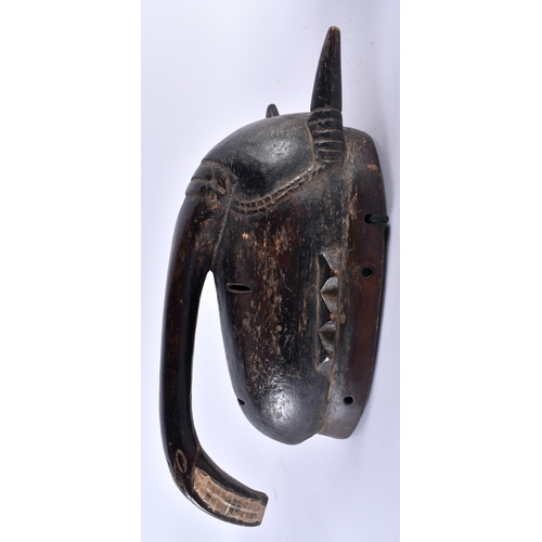 460 - AN UNUSUAL AFRICAN TRIBAL CARVED WOOD LONG NOSED MASK formed with horns and angular motifs. 31 cm x ... 