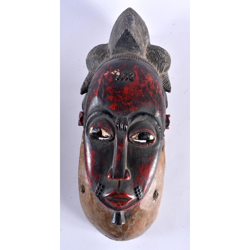 461 - TWO AFRICAN IVORY COAST TRIBAL RED PAINTED GURO WOOD MASKS. Largest 44 cm x 15 cm. (2)