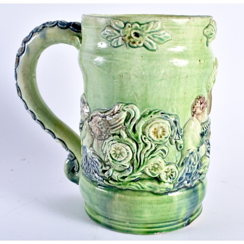 470 - A RARE ANTIQUE GREEN GLAZED WHIELDON TYPE MAJOLICA MUG decorated in relief with figures. 14 cm x 12 ... 