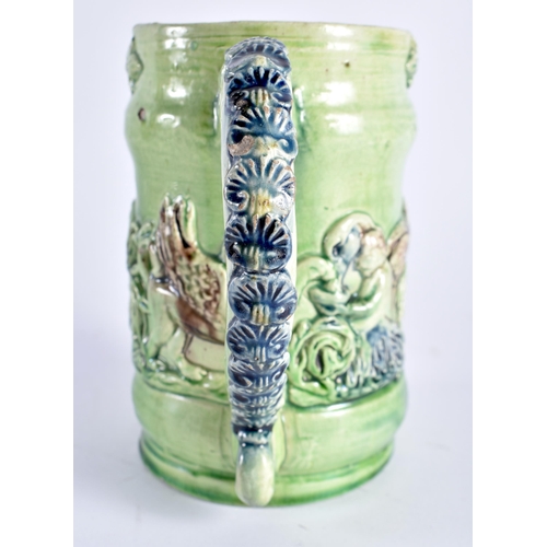 470 - A RARE ANTIQUE GREEN GLAZED WHIELDON TYPE MAJOLICA MUG decorated in relief with figures. 14 cm x 12 ... 