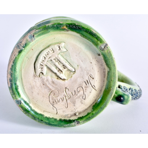 470 - A RARE ANTIQUE GREEN GLAZED WHIELDON TYPE MAJOLICA MUG decorated in relief with figures. 14 cm x 12 ... 