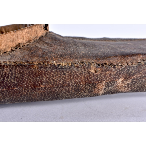 481 - AN EARLY NORTH AMERICAN SHARK/RAY SKIN SHAGREEN WRAPPED INUIT CANOE together with a carved Stone fig... 