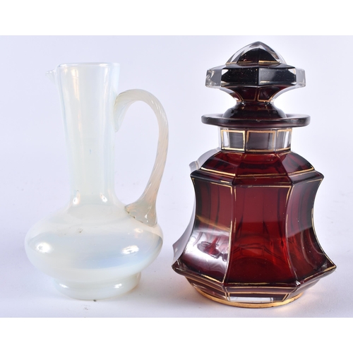 483 - AN ANTIQUE BOHEMIAN GILDED RUBY GLASS SCENT BOTTLE AND STOPPER together with an opaline glass jug. L... 