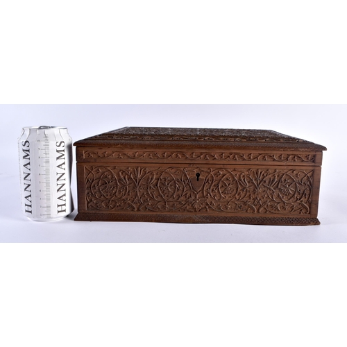 488 - A LARGE 19TH CENTURY ANGLO INDIAN CARVED WOOD COUNTRY HOUSE CASKET decorated with foliage and scroll... 