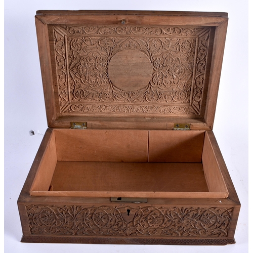 488 - A LARGE 19TH CENTURY ANGLO INDIAN CARVED WOOD COUNTRY HOUSE CASKET decorated with foliage and scroll... 