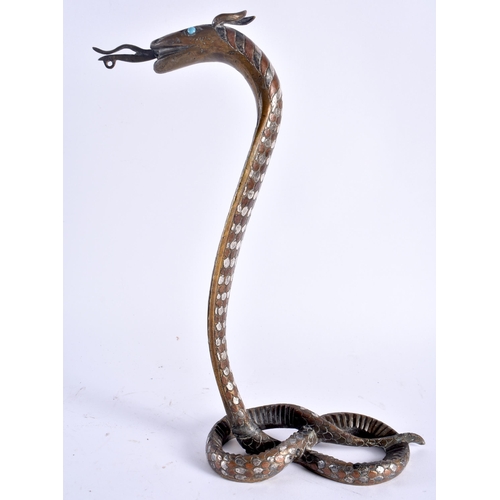 490 - A RARE 19TH CENTURY INDIAN MIDDLE EASTERN SILVER OVERLAID BRONZE COBRA inset with turquoise, decorat... 