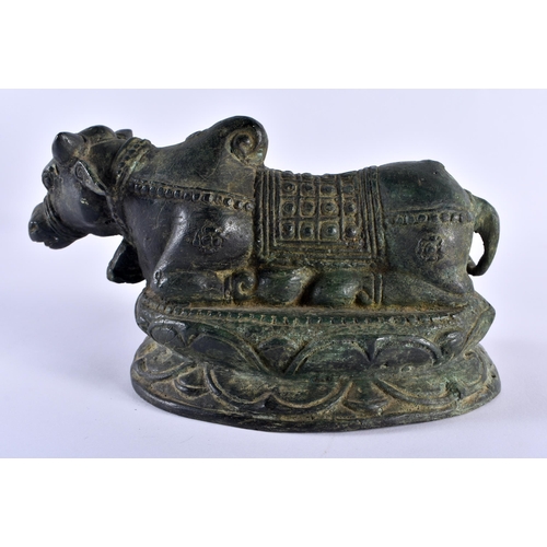 502 - A 19TH CENTURY INDIAN BRONZE FIGURE OF A NANDI BULL modelled recumbent. 18 cm x 12 cm.