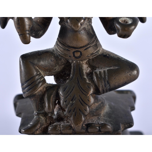 516 - AN 18TH CENTURY INDIAN BRONZE FIGURE OF A BUDDHISTIC DEITY modelled upon a stepped base. 12 cm high.