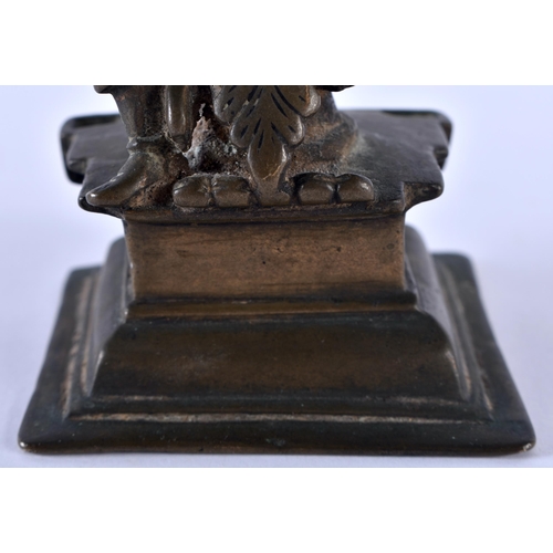 516 - AN 18TH CENTURY INDIAN BRONZE FIGURE OF A BUDDHISTIC DEITY modelled upon a stepped base. 12 cm high.