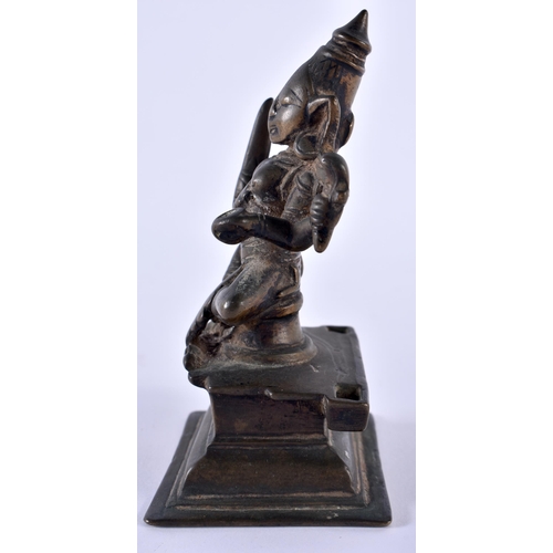 516 - AN 18TH CENTURY INDIAN BRONZE FIGURE OF A BUDDHISTIC DEITY modelled upon a stepped base. 12 cm high.