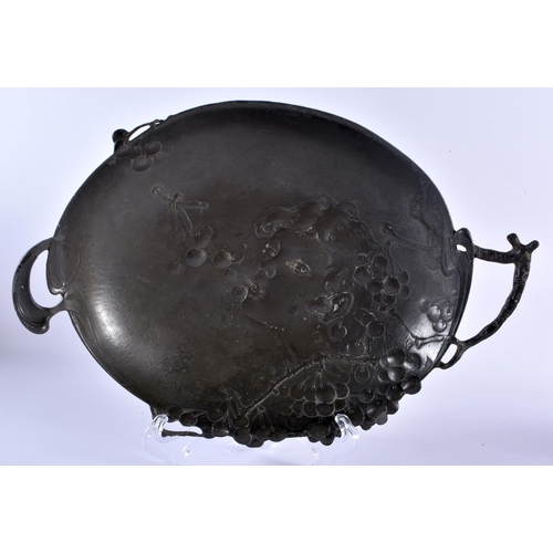 522 - AN ART NOUVEAU TWIN HANDLED PEWTER DISH together with a figural lamp. Largest 28 cm high. (2)