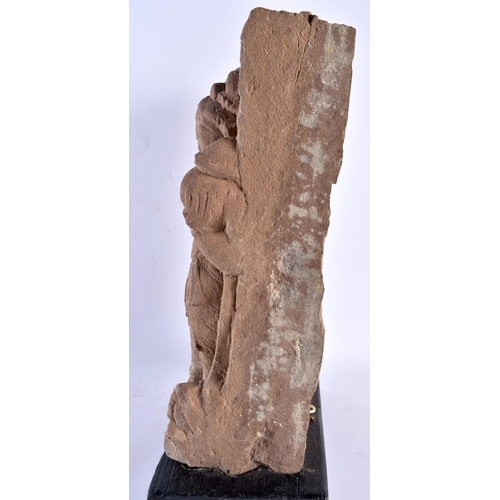 546 - A LARGE EARLY INDIAN VOTIVE CARVED SANDSTONE SHRINE upon a wooden base. 38 cm x 22 cm.