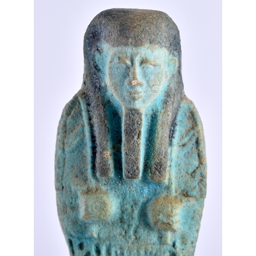 549 - AN EGYPTIAN FAIENCE GLAZED USHABTI FIGURE upon a later ebonised base. Ushabti 11 cm high.