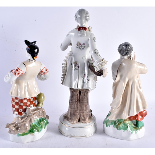 565 - A PAIR OF RUSSIAN UKRANIAN PORCELAIN FIGURES together with another. Largest 33 cm high. (3)