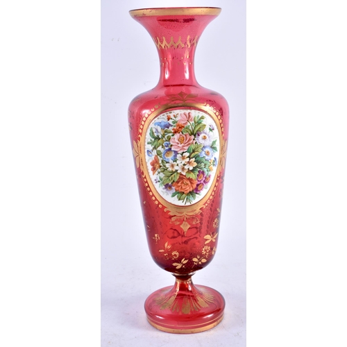 577 - A LATE 19TH CENTURY BOHEMIAN RUBY GLASS ENAMELLED VASE painted with flowers. 30 cm high.