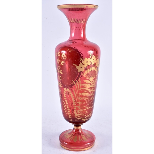 577 - A LATE 19TH CENTURY BOHEMIAN RUBY GLASS ENAMELLED VASE painted with flowers. 30 cm high.