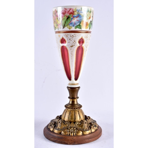 596 - A LARGE 19TH CENTURY BOHEMIAN RUBY AND WHITE ENAMELLED VASE painted with flowers, upon a gilt repous... 