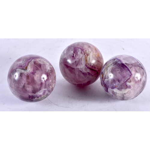 598 - THREE CONTINENTAL CARVED PURPLE STONE BALLS possibly Bluejohn. 6 cm diameter. (3)