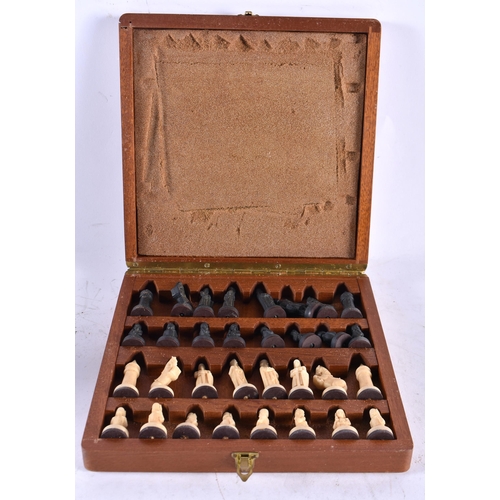 599 - A BOXED CHESS SET. Board 20 cm square closed.