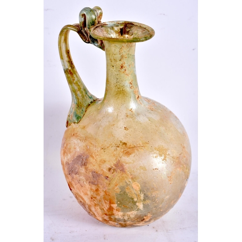 605 - A ROMAN GLASS JUG together with six smaller glass vessels. Largest 12.5 cm high. (7)