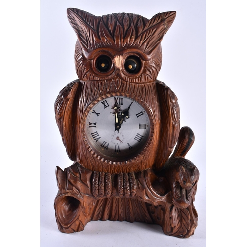 626 - A LARGE BLACK FOREST BAVARIAN OWL CLOCK together with a pair of antlers. Largest 34 cm x 18 cm. (2)