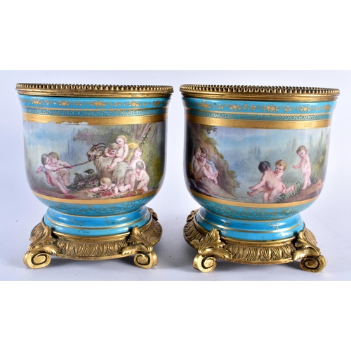 634 - A LARGE PAIR OF 19TH CENTURY FRENCH SEVRES PORCELAIN BRONZE PLANTERS painted with figures within lan... 