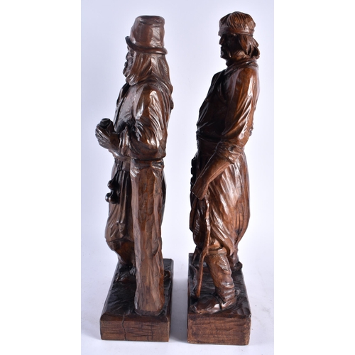 639 - A LARGE PAIR OF EARLY 20TH CENTURY CONTINENTAL CARVED WOOD FIGURES. 44 cm high.