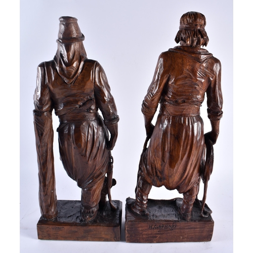 639 - A LARGE PAIR OF EARLY 20TH CENTURY CONTINENTAL CARVED WOOD FIGURES. 44 cm high.