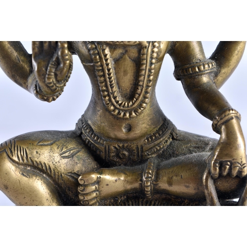 653 - A 19TH CENTURY MIDDLE EASTERN INDIAN BRONZE FIGURE OF A DEITY modelled with multiple arms. 16 cm x 8... 