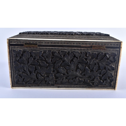 668 - A 19TH CENTURY MIDDLE EASTERN ANGLO INDIAN CARVED WOOD CASKET decorated with buildings and foliage. ... 