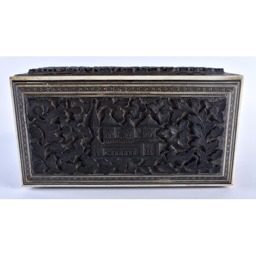 668 - A 19TH CENTURY MIDDLE EASTERN ANGLO INDIAN CARVED WOOD CASKET decorated with buildings and foliage. ... 