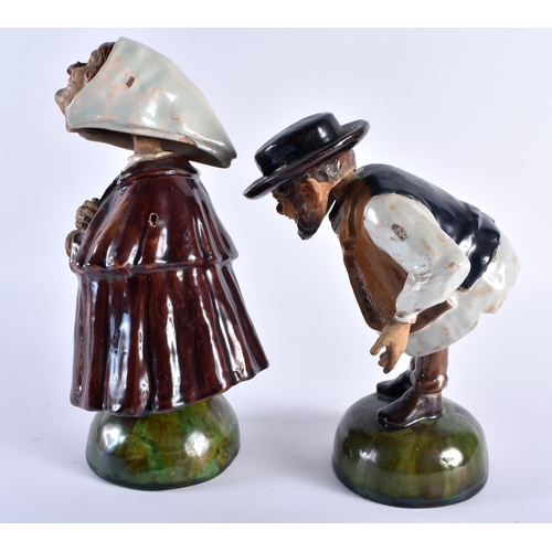 707 - A RARE PAIR OF ANTIQUE PORTUGUESE NODDING HEAD POTTERY FIGURES modelled as peasants. 22 cm high.