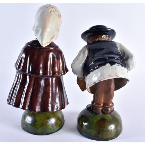 707 - A RARE PAIR OF ANTIQUE PORTUGUESE NODDING HEAD POTTERY FIGURES modelled as peasants. 22 cm high.