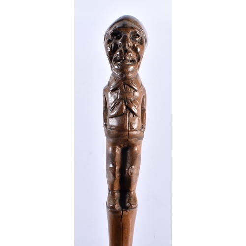 712 - AN ANTIQUE CONTINENTAL CARVED ELONGATED HEAD WOOD WALKING CANE. 88 cm long.