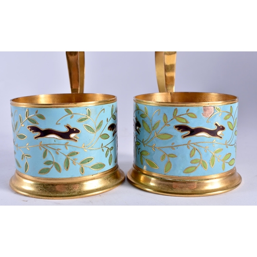 718 - A PAIR OF RUSSIAN YELLOW METAL AND ENAMEL CUP HOLDERS. 9 cm wide.